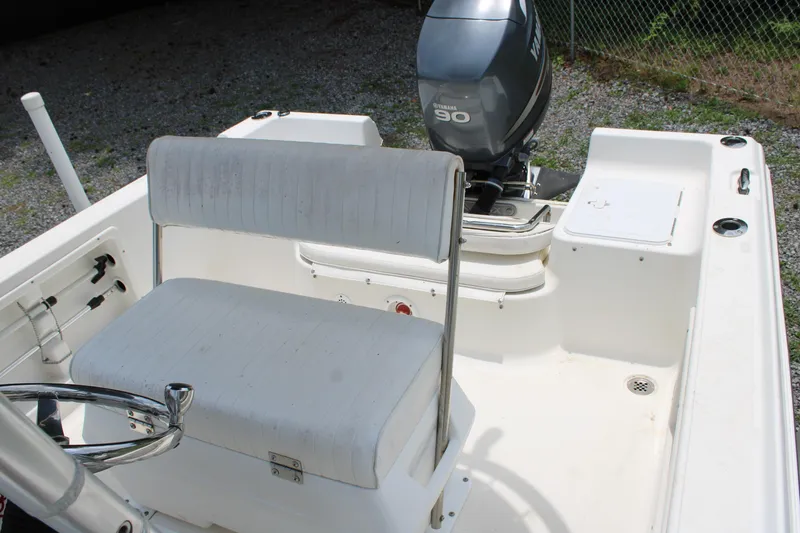 Slide: The Image of 2012 Sea Fox 187 Center Console boat interior with Yamaha 90 engine, white seating, and steering wheel. - 16