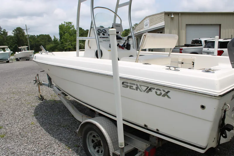 Slide: The Image of 2012 Sea Fox 187 Center Console boat on trailer, parked outdoors near a building. - 20