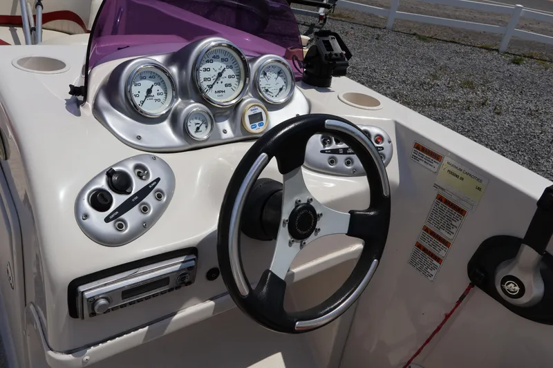 Slide: The Image of Steering console of a 2008 Starcraft 2000 IO Limited boat with gauges and controls. - 29