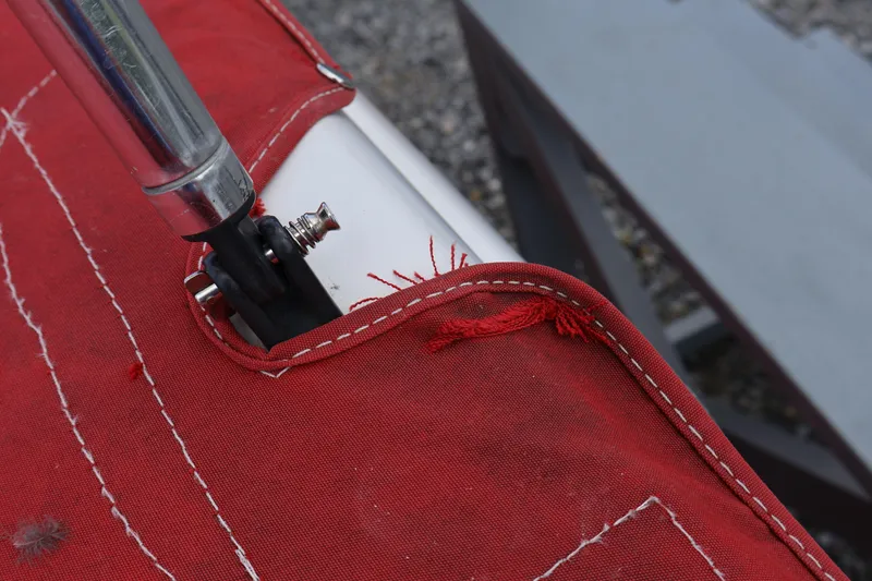 Slide: The Image of Close-up of a red fabric cover with metal pole on a 2008 Starcraft 2000 IO Limited. - 48