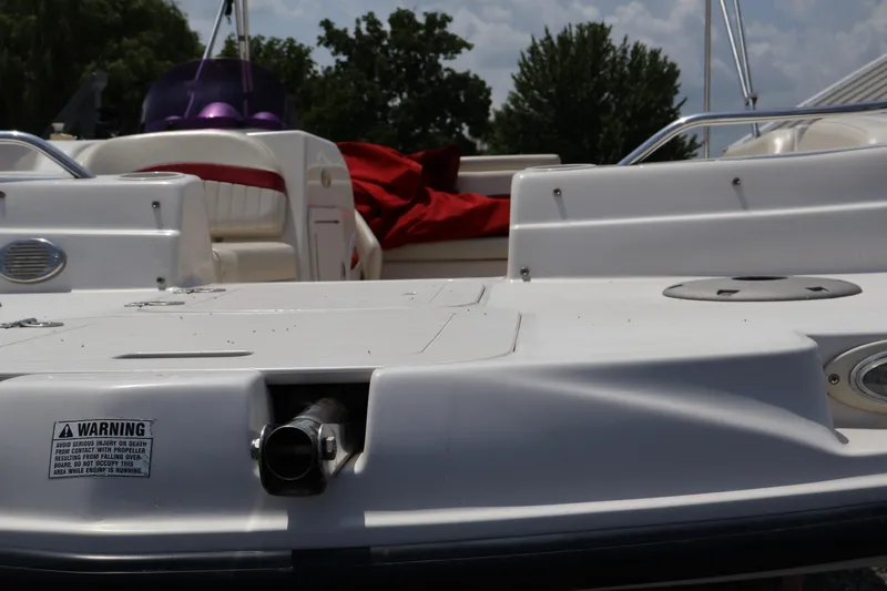 Slide: The Image of 2008 Starcraft 2000 IO Limited boat interior with seating and warning label. - 39