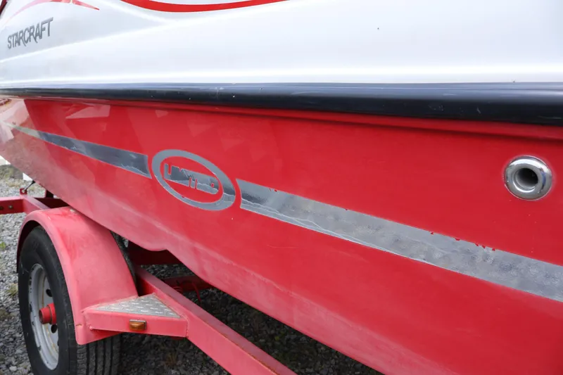 Slide: The Image of Red and white 2008 Starcraft 2000 IO Limited boat on trailer. - 11