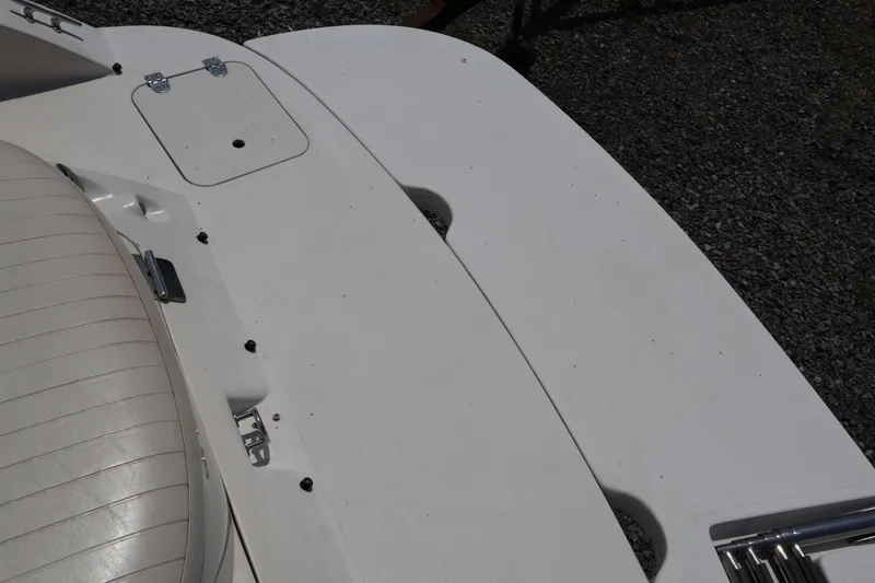Slide: The Image of 2008 Starcraft 2000 IO Limited boat deck with seating and storage hatch. - 17
