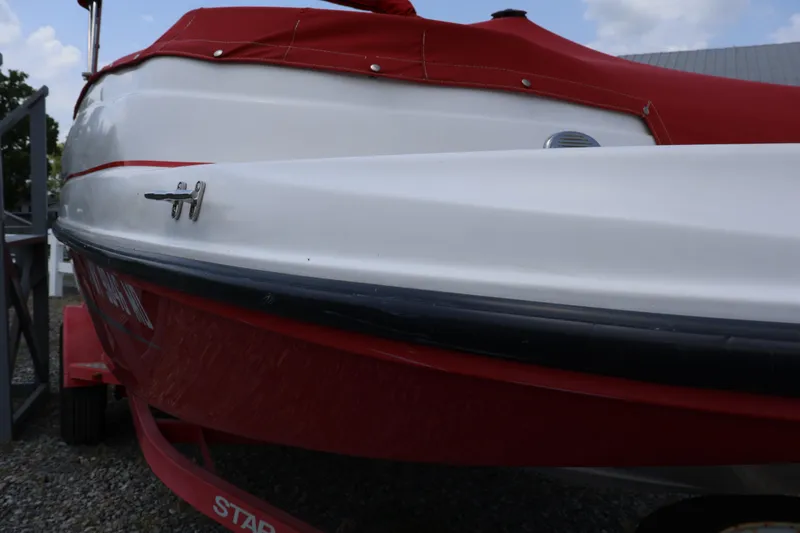 Slide: The Image of Red and white 2008 Starcraft 2000 IO Limited boat on trailer. - 9