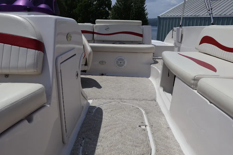 Slide: The Image of 2008 Starcraft 2000 IO Limited boat interior with white and red seating, carpeted floor. - 27