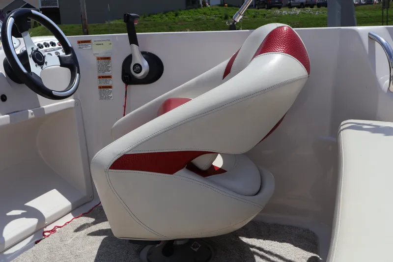 Slide: The Image of 2008 Starcraft 2000 IO Limited boat interior with red and white seating and steering wheel. - 25
