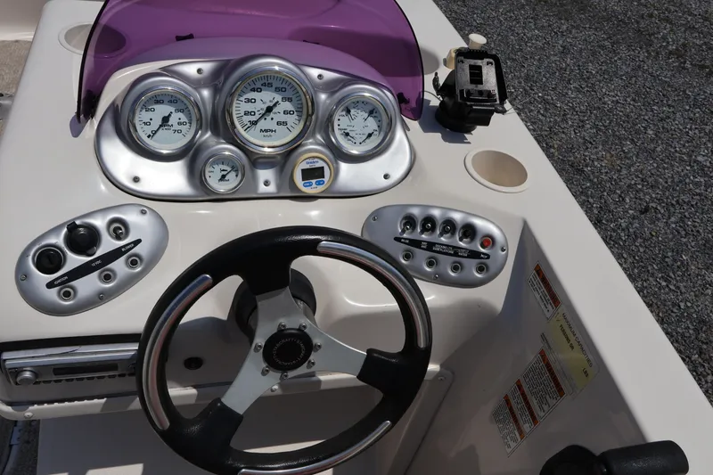 Slide: The Image of Dashboard of a 2008 Starcraft 2000 IO Limited boat with steering wheel and gauges. - 31