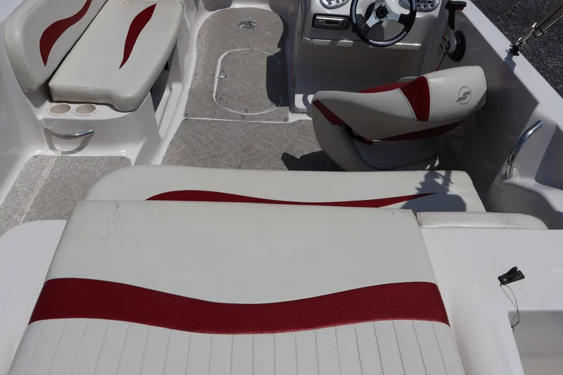 Slide: The Image of Interior of a 2008 Starcraft 2000 IO Limited boat with red and white seating. - 20