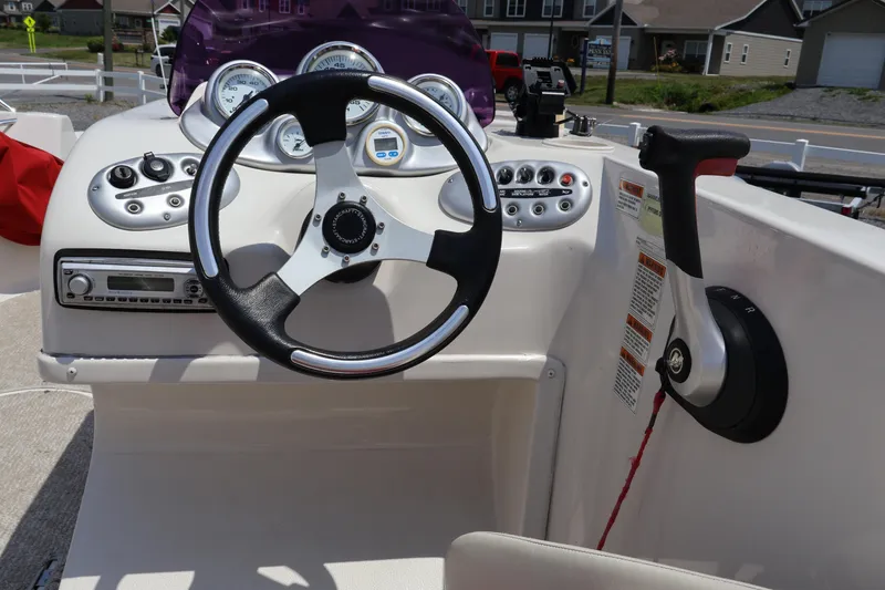 Slide: The Image of Steering console of 2008 Starcraft 2000 IO Limited boat with gauges and controls. - 30