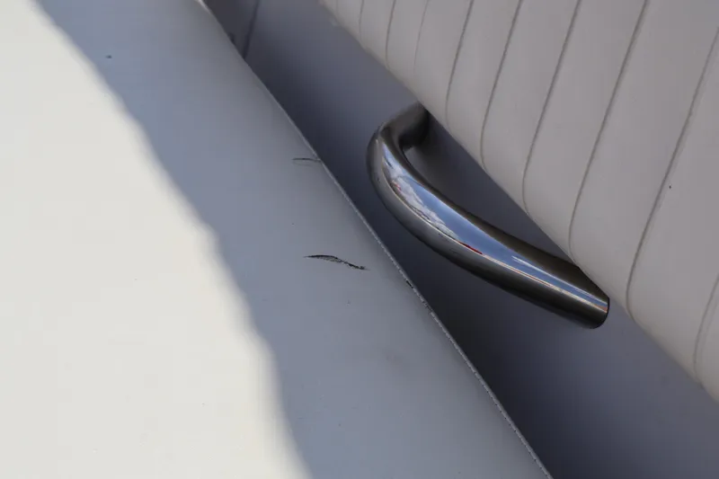 Slide: The Image of Close-up of a 2008 Starcraft 2000 IO Limited boat seat with metal handle. - 24