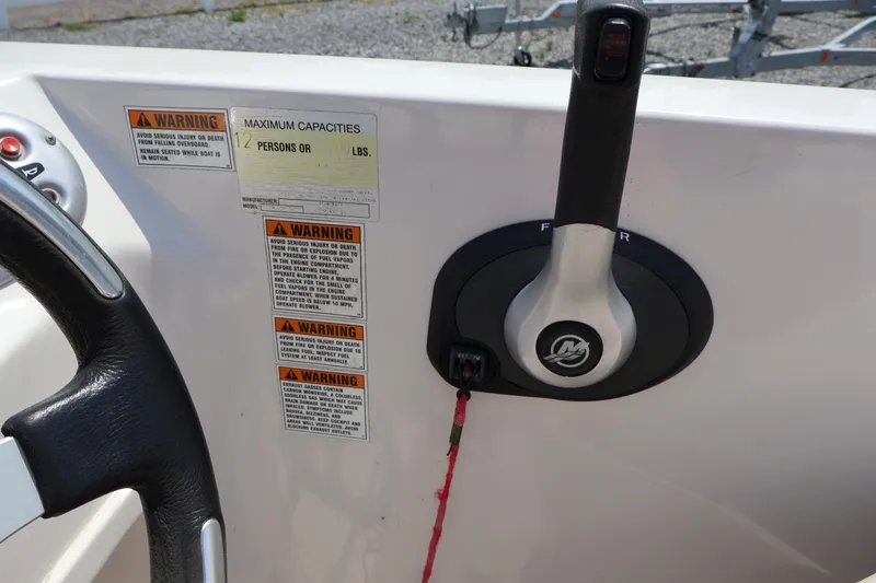 Slide: The Image of Control panel of a 2008 Starcraft 2000 IO Limited boat with warning labels. - 32