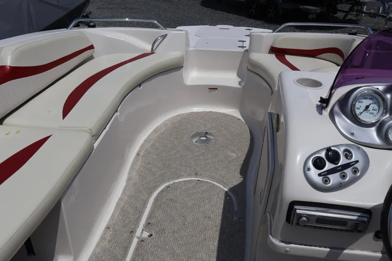 Slide: The Image of 2008 Starcraft 2000 IO Limited boat interior with red and white seating and control panel. - 41