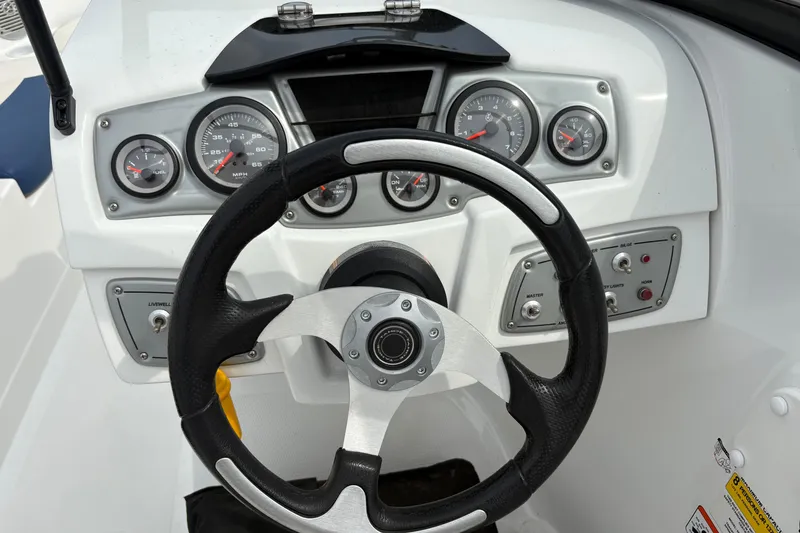 Slide: The Image of Steering wheel and dashboard of a 2018 Tahoe 500 TF boat, featuring gauges and controls. - 10