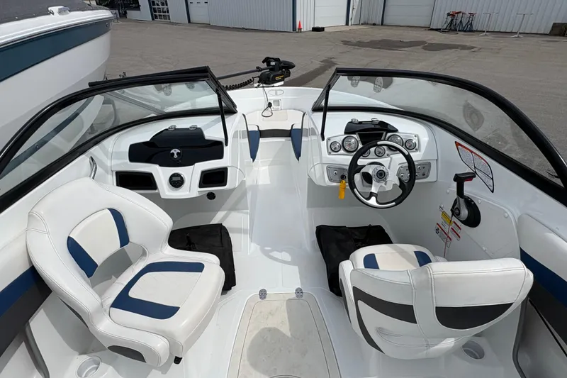 Slide: The Image of 2018 Tahoe 500 TF boat interior with dual seating and modern dashboard controls. - 4