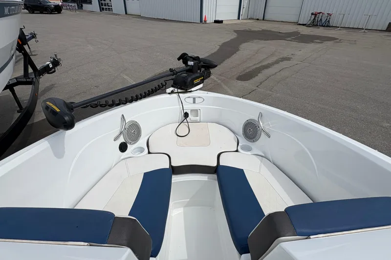 Slide: The Image of 2018 Tahoe 500 TF boat interior with blue and white seating, docked outdoors. - 13