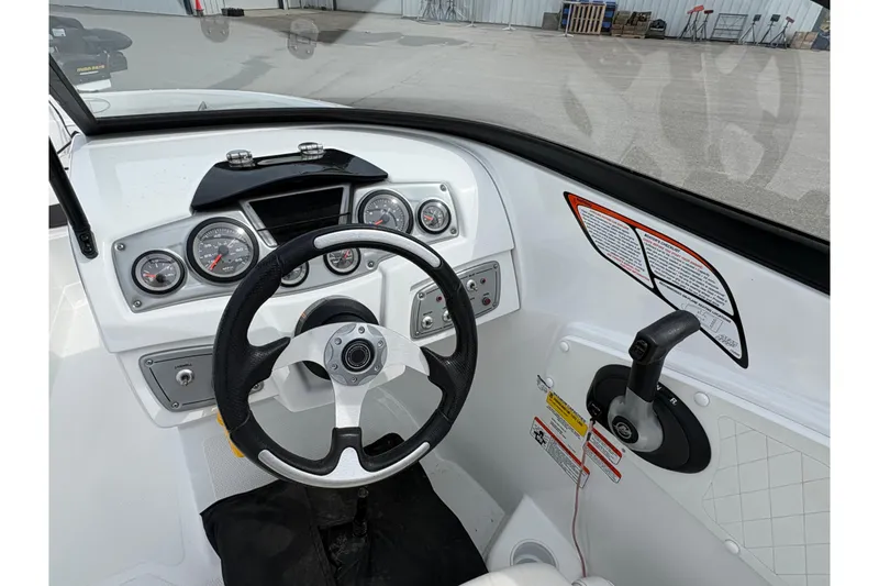 Slide: The Image of Interior view of 2018 Tahoe 500 TF boat dashboard with steering wheel and controls. - 9
