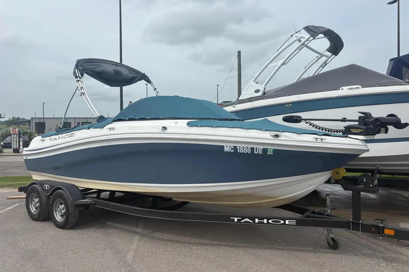 The Image of 2018 Tahoe 500 TF boat on trailer, parked outdoors, with cover and canopy. - 0