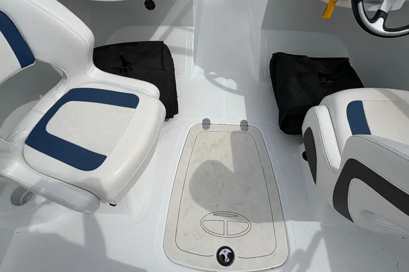 Slide: The Image of Interior of a 2018 Tahoe 500 TF boat with white and blue seating. - 7