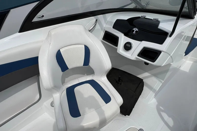 Slide: The Image of 2018 Tahoe 500 TF boat interior with white and blue seating and modern dashboard. - 8