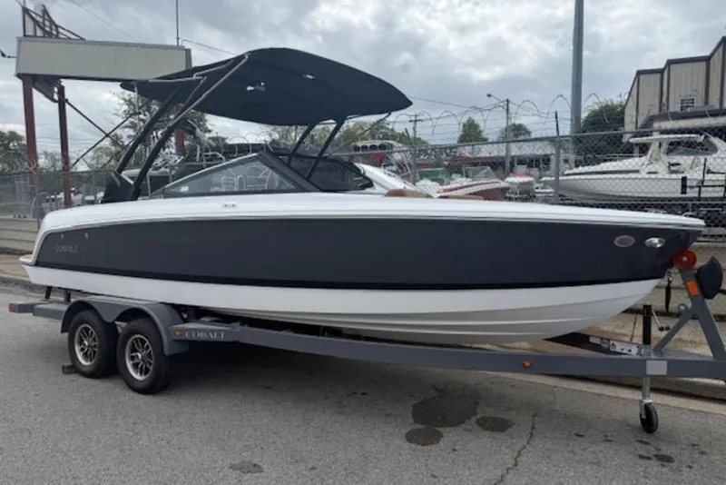 Slide: The Image of 2026 Cobalt CS22 boat on trailer, parked outdoors, under cloudy sky. - 3