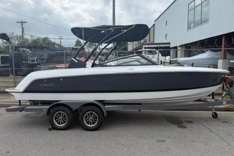Slide: The Image of 2026 Cobalt CS22 boat on trailer, sleek design, black and white color scheme. - 7