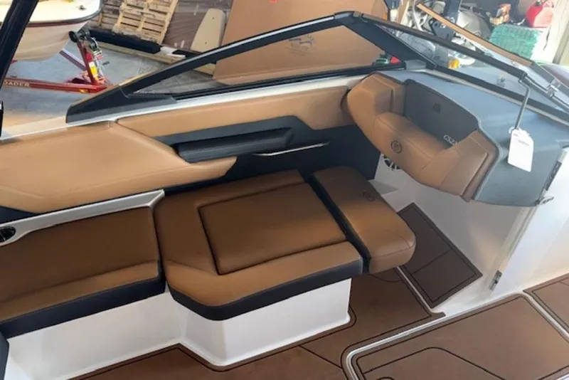 Slide: The Image of 2026 Cobalt CS22 boat interior with tan leather seating and modern dashboard design. - 4