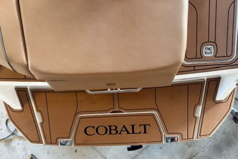 Slide: The Image of 2026 Cobalt CS22 boat deck with tan upholstery and wood finish. - 11