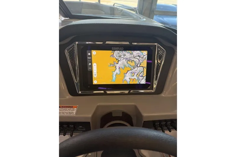 Slide: The Image of Dashboard of 2026 Chaparral 23 SSi boat featuring a Simrad navigation display. - 5