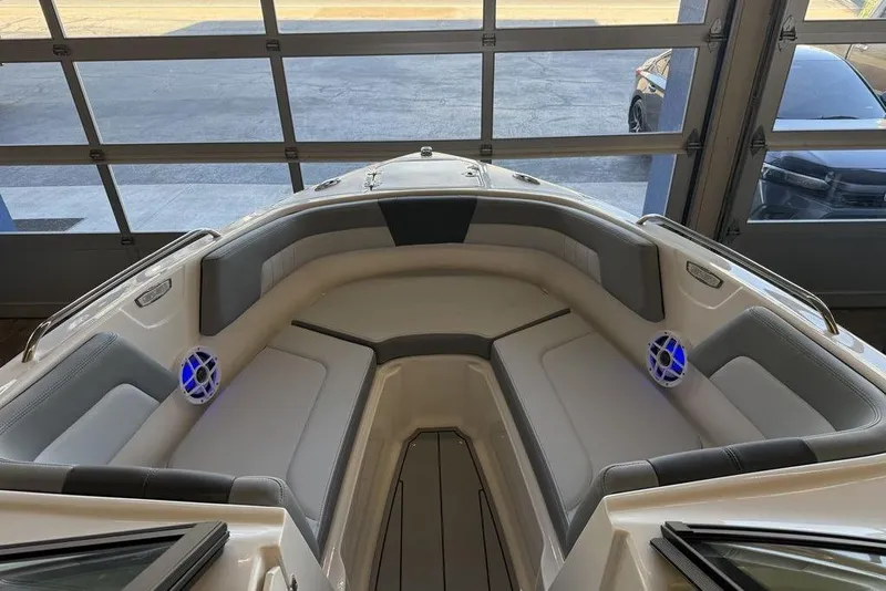 Slide: The Image of 2026 Chaparral 23 SSi boat interior with cushioned seating and blue LED speakers. - 12