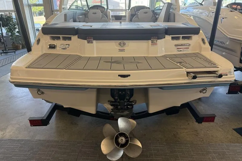 Slide: The Image of 2026 Chaparral 23 SSi boat rear view, showcasing swim platform and propeller in showroom. - 6