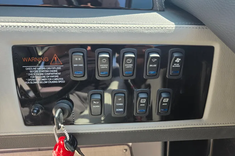 Slide: The Image of Control panel of a 2020 Regal 2300 Bowrider boat with various switches and warning label. - 6