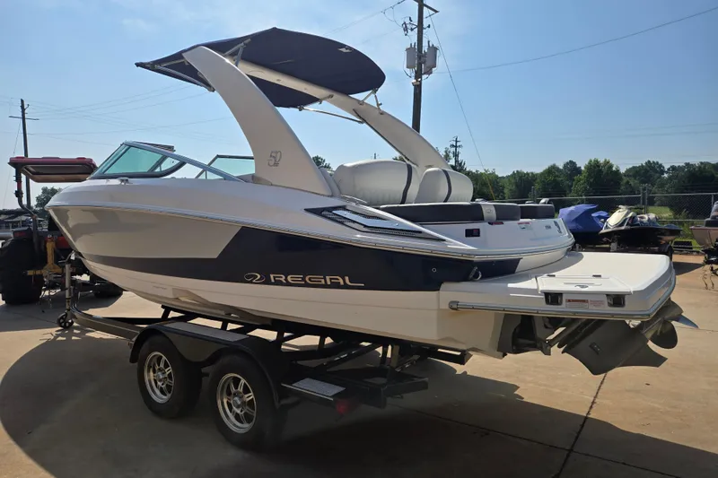 Slide: The Image of 2020 Regal 2300 Bowrider boat on trailer, featuring sleek design and modern amenities. - 20
