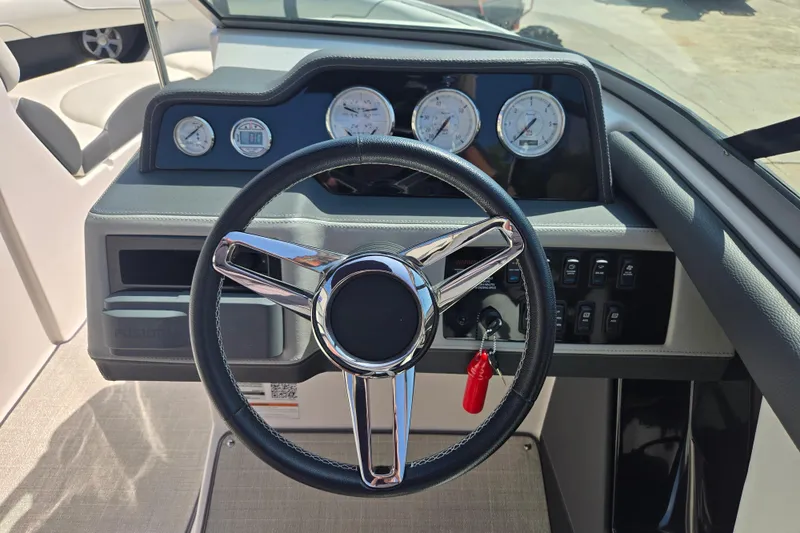 Slide: The Image of Steering wheel and dashboard of 2020 Regal 2300 Bowrider boat, featuring gauges and controls. - 8