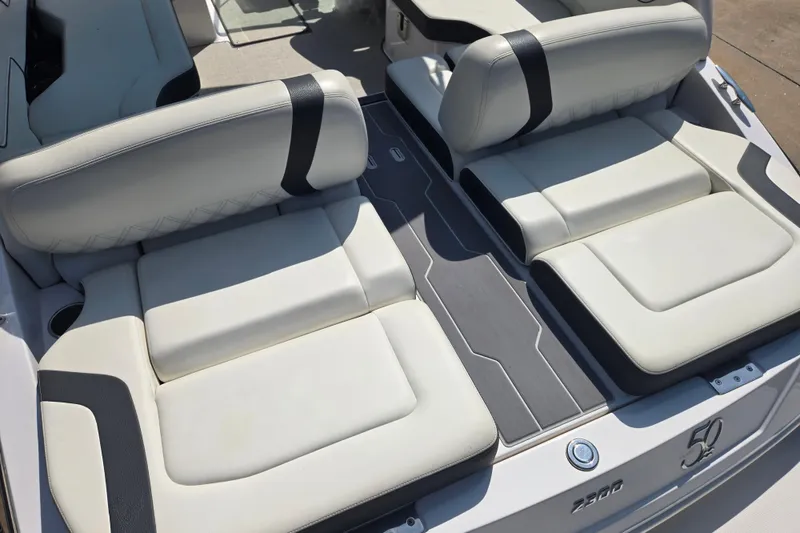 Slide: The Image of 2020 Regal 2300 Bowrider boat interior with white cushioned seating and sleek design. - 19