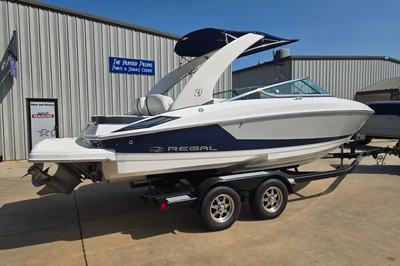Slide: The Image of 2020 Regal 2300 Bowrider boat on trailer at service center, side view. - 3