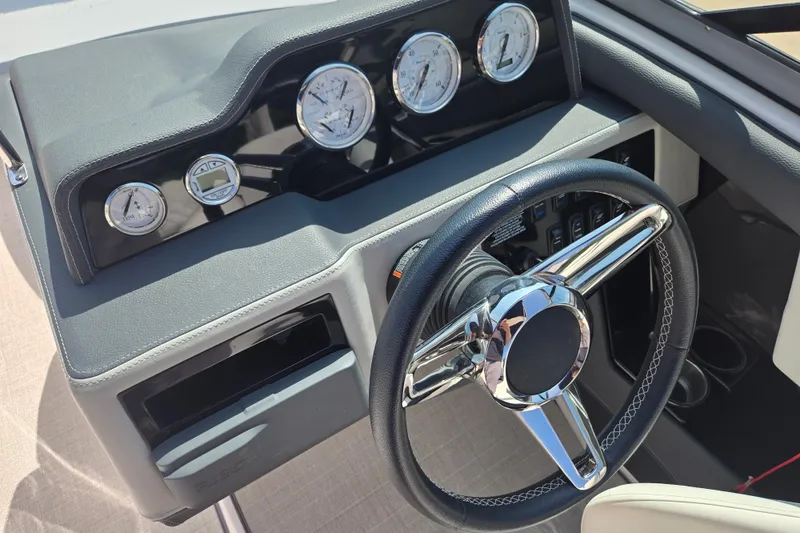 Slide: The Image of Steering wheel and dashboard of 2020 Regal 2300 Bowrider boat with gauges. - 13