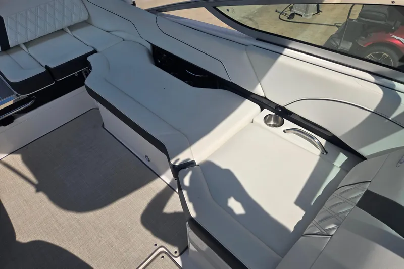 Slide: The Image of Interior of a 2020 Regal 2300 Bowrider boat with white seating and cup holder. - 11