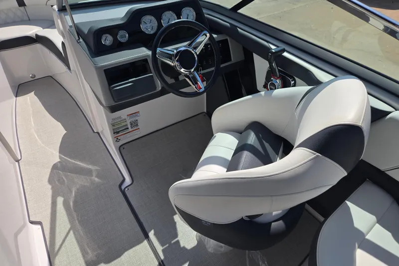Slide: The Image of Interior of 2020 Regal 2300 Bowrider boat with steering wheel and captain's chair. - 16