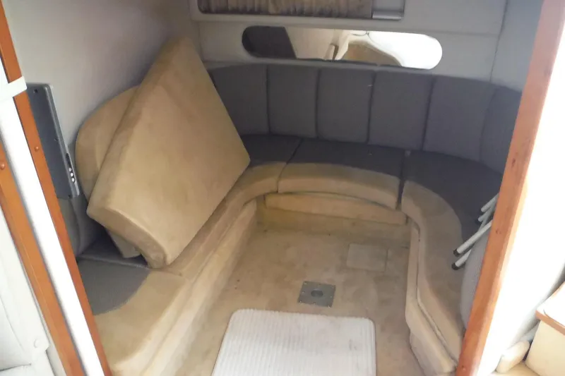 Slide: The Image of 2005 Chaparral Signature 350 cabin interior with curved seating and beige cushions. - 28