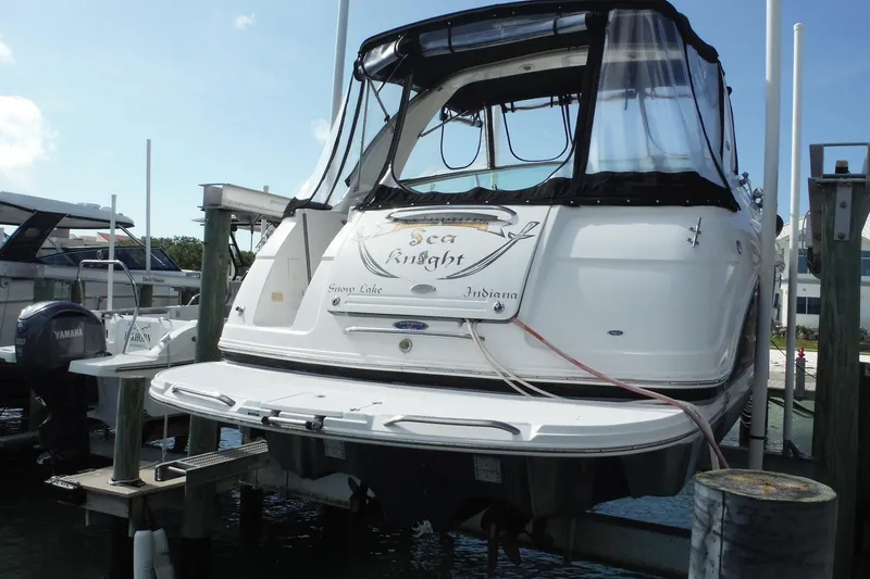 Slide: The Image of 2005 Chaparral Signature 350 boat docked, rear view with canopy and name "Sea Knight." - 45