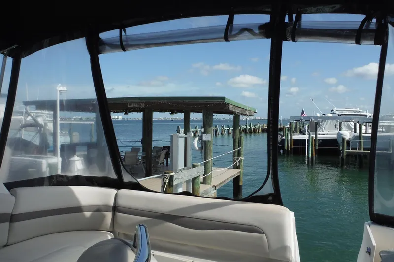 Slide: The Image of 2005 Chaparral Signature 350 yacht interior with marina view, clear skies, and docked boats. - 30