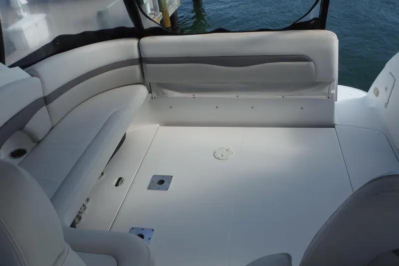 Slide: The Image of 2005 Chaparral Signature 350 boat interior with white seating and spacious deck area. - 12