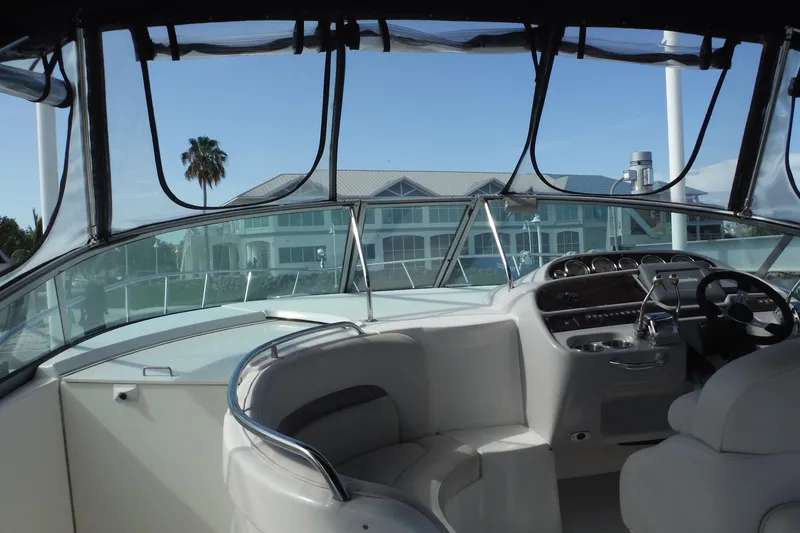 Slide: The Image of 2005 Chaparral Signature 350 boat interior with helm and seating, overlooking waterfront buildings. - 32