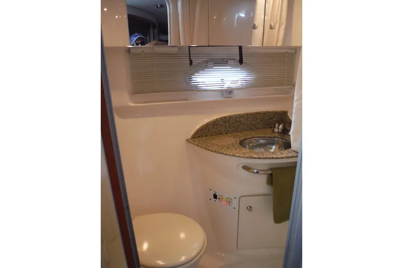 Slide: The Image of 2005 Chaparral Signature 350 boat bathroom with sink, toilet, and granite countertop. - 24