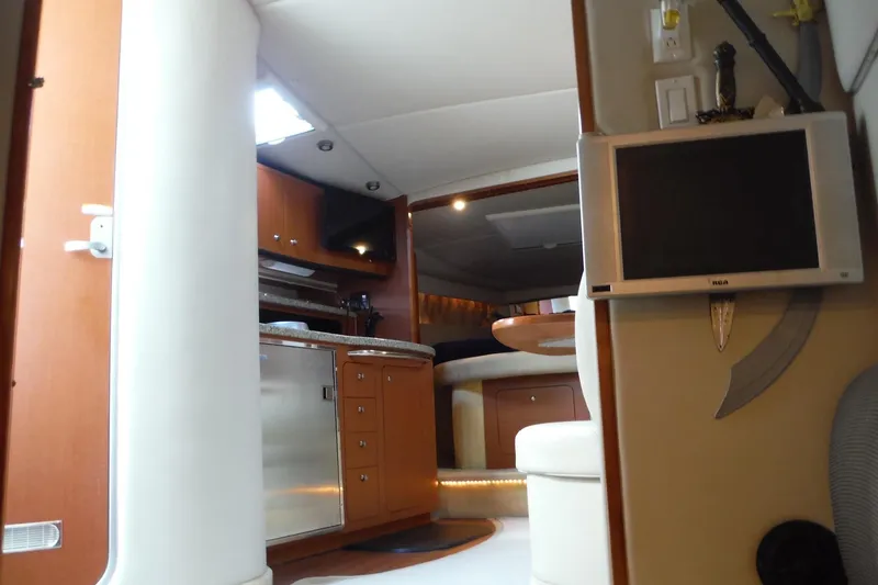 Slide: The Image of Interior of 2005 Chaparral Signature 350 yacht with modern amenities and wooden cabinetry. - 22