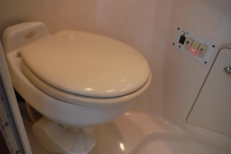 Slide: The Image of 2005 Chaparral Signature 350 boat bathroom with toilet and control panel. - 25