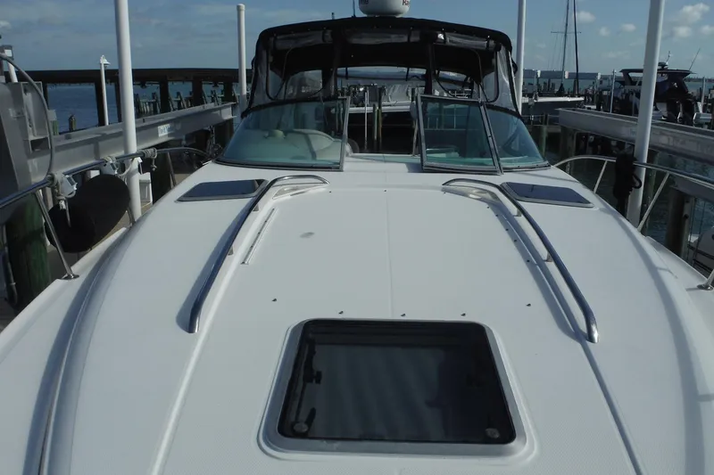 Slide: The Image of 2005 Chaparral Signature 350 yacht docked, showcasing sleek deck design and windshield. - 11