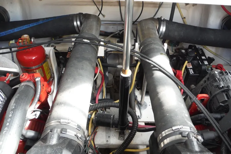 Slide: The Image of Engine compartment of a 2005 Chaparral Signature 350 boat, featuring hoses and wiring. - 36