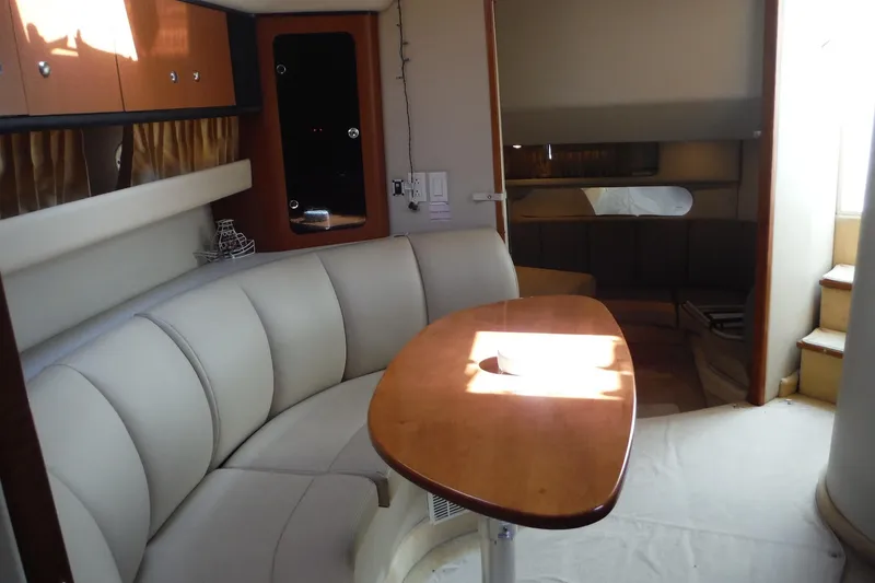 Slide: The Image of Interior of 2005 Chaparral Signature 350 yacht with elegant seating and wooden table. - 18