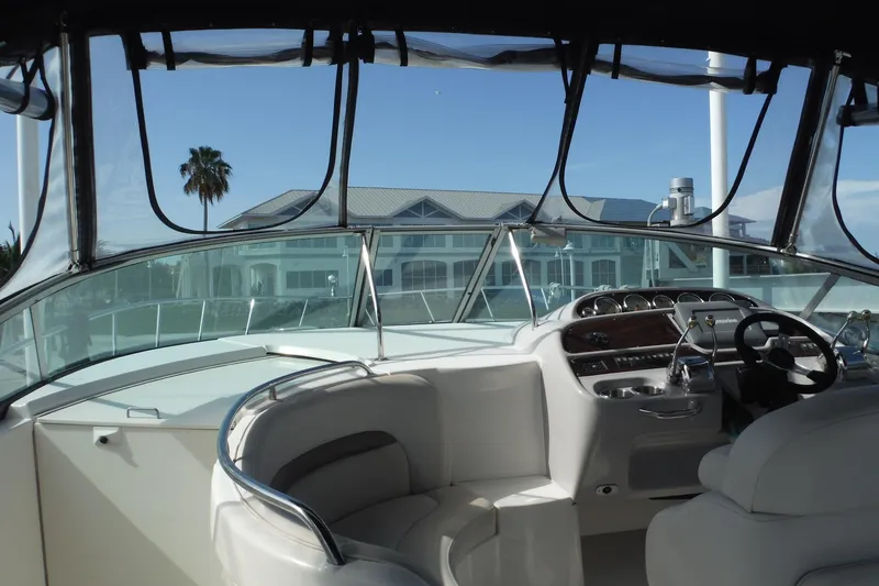 Slide: The Image of 2005 Chaparral Signature 350 yacht interior with steering wheel and dashboard, overlooking waterfront property. - 31